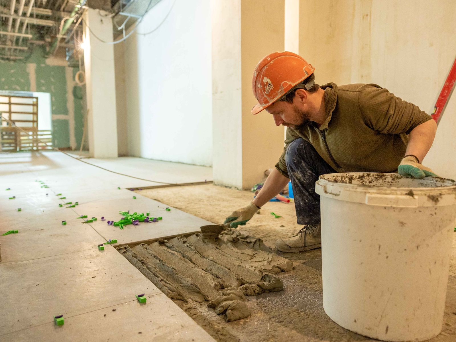 Construction Worker Laying Tile